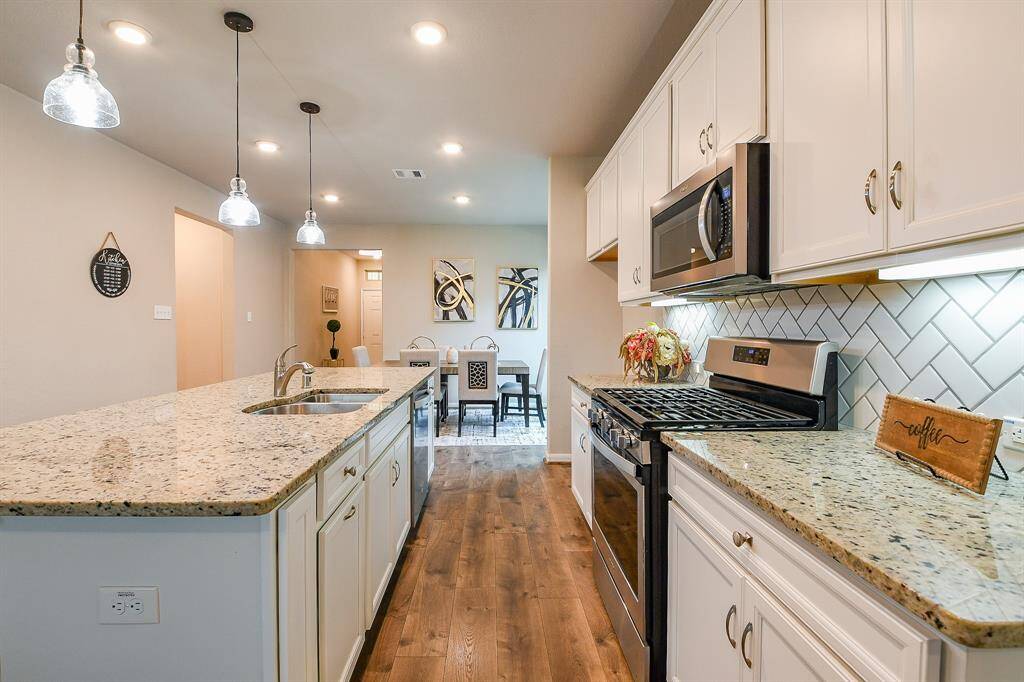 . . . and this bright kitchen sits right off a stunning living area, with built-in fireplace. Rich laminate flooring is durable and good looking.