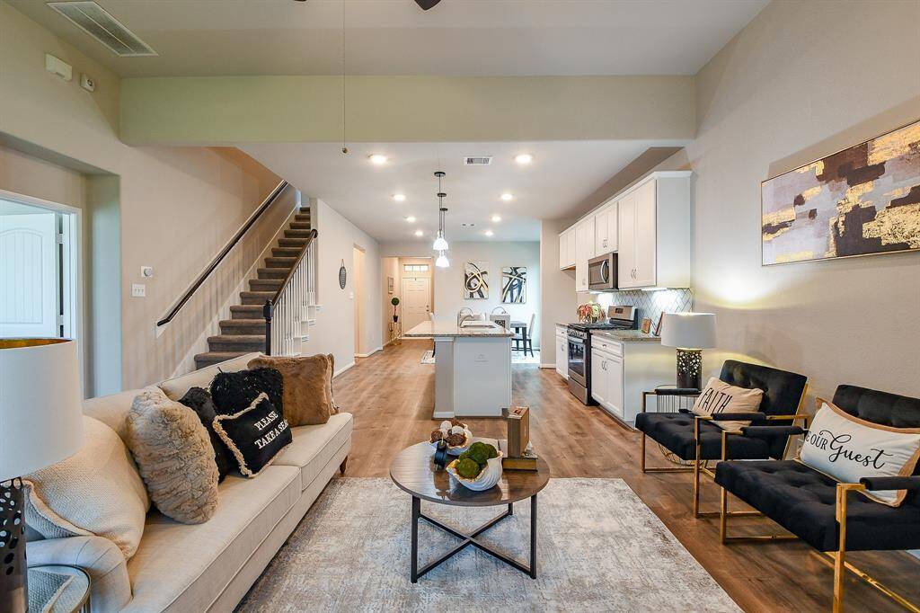 Vanilla toned cabinetry is everywhere you need it to be, with creamy granite topped counters and attractive subway style tile backsplash.
