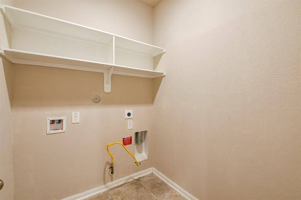 A stunning high ceiling, rich carpeting and a wall of windows graces your primary suite, with ensuite bath through the double doors, right.