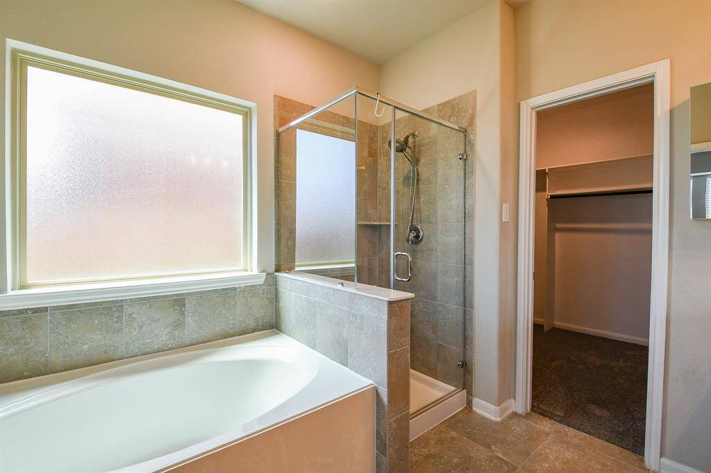 The utility room is ready with handy hook-ups for dual laundry appliances, with welcomed storage, above.