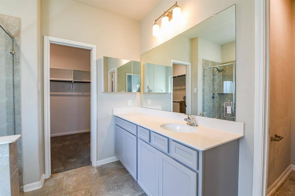 Your spectacular primary suite is conveniently located off the 1st floor living area, with easy access to the stairs.