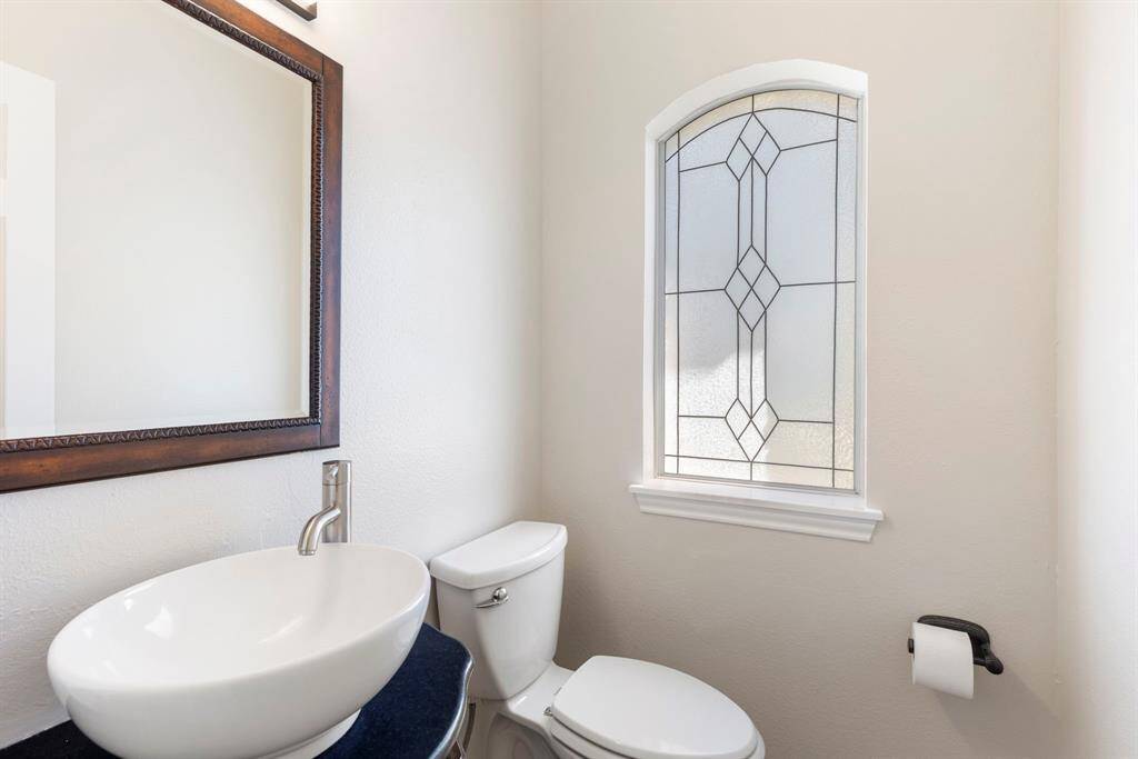 Guest half bath with updated vanity and sink - located off of the foyer