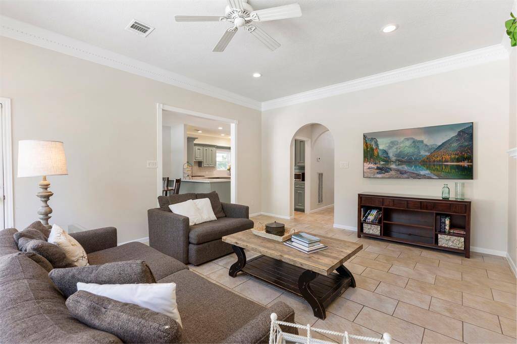The custom millwork is impressive featuring dentil crown moulding and cased doorway to the kitchen and breakfast room area.