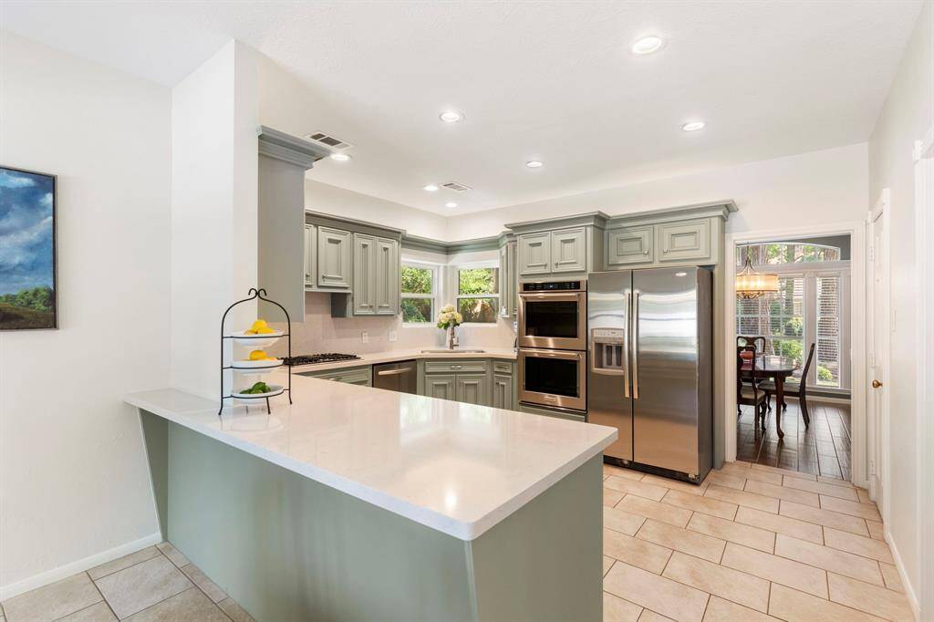 The cook in the family will love the ample counterspace and deep stainless-steel single basin sink -perfectly positioned beneath corner windows, adding both charm and practicality. Bright and airy, the kitchen is enhanced with updated recessed lighting.