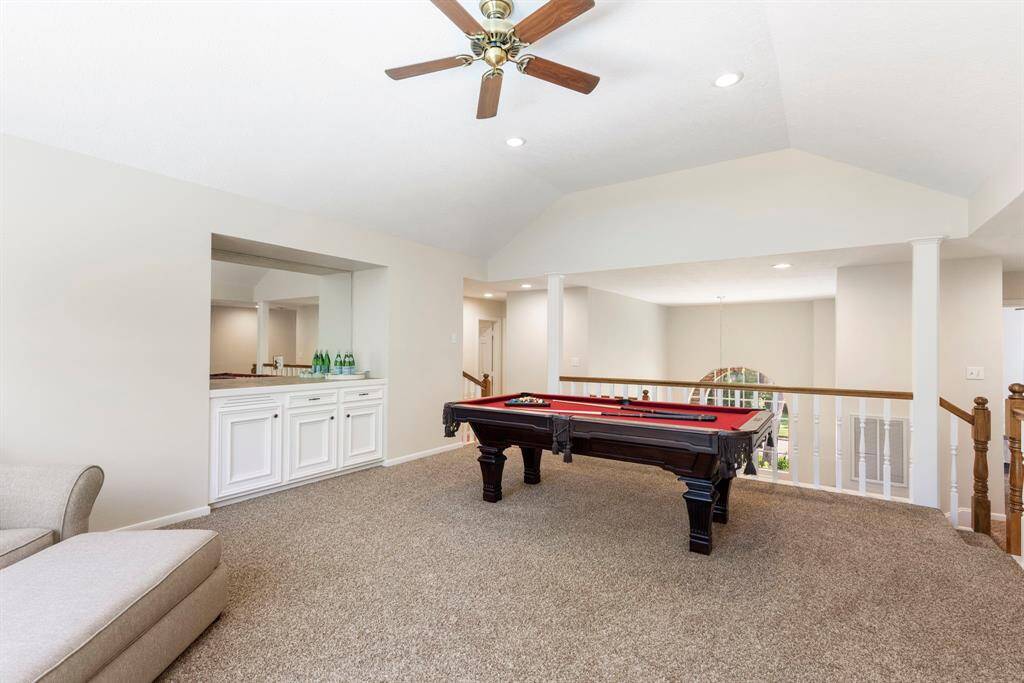 Perfectly positioned at the center of the home’s upper level, this oversized space connects all the secondary bedrooms, creating a natural gathering spot for family fun or entertaining guests.  Built-in cabinetry with a tile countertop adds both style and functionality—ideal for storing snacks, games, or other entertainment essentials.