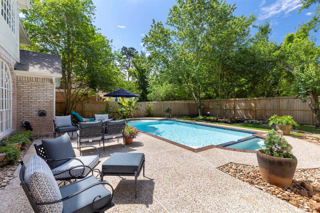 An expansive deck provides multiple gathering areas, perfect for relaxing, entertaining, or dining al fresco.