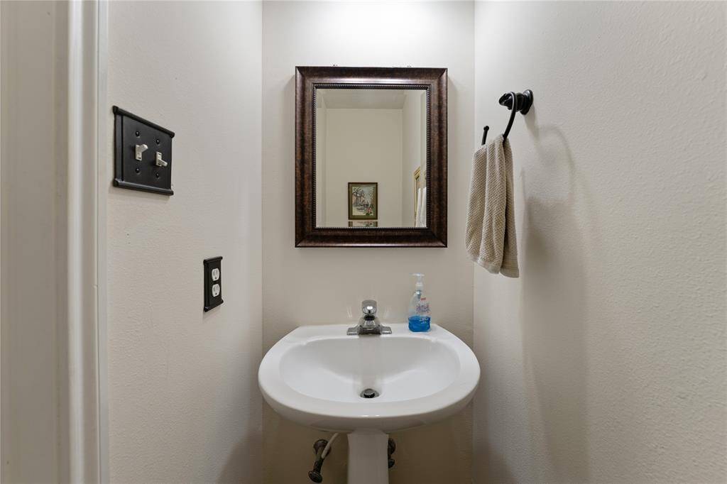 Spacious carpeted room with neutral walls, ceiling fan, and ample natural light. Ideal for a family setting.