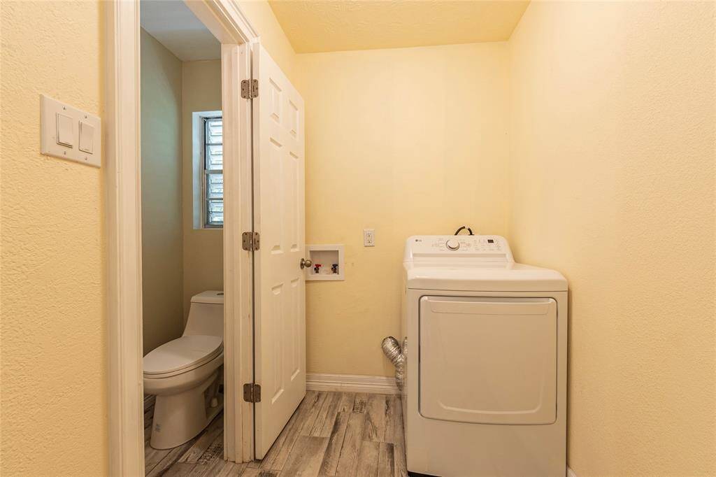 LAUNDRY ROOM WITH HALF BATH ON FIRST LEVEL