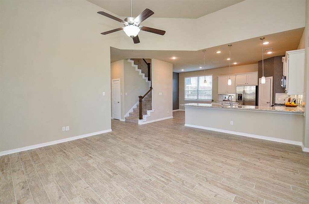 Wood-look tile flooring brings warmth and durability, complementing the natural light pouring in through the windows.
