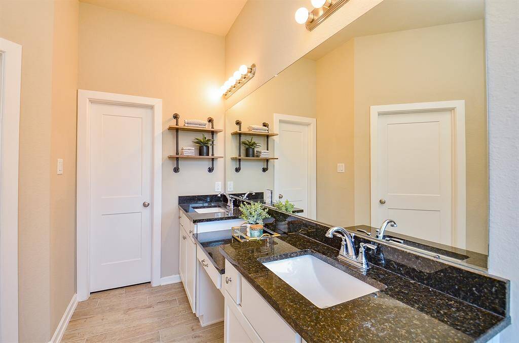 Step into your serene ensuite, designed to be both functional and indulgent. You'll find dual sinks with separate vanities, including a dedicated makeup or grooming area for added convenience.
