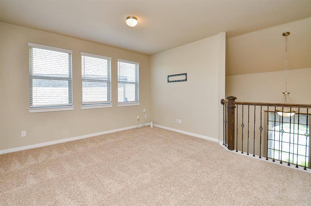 At the top of the stairs, you’ll find a spacious game room that’s ready for anything—movie nights, playtime, or a home office setup.