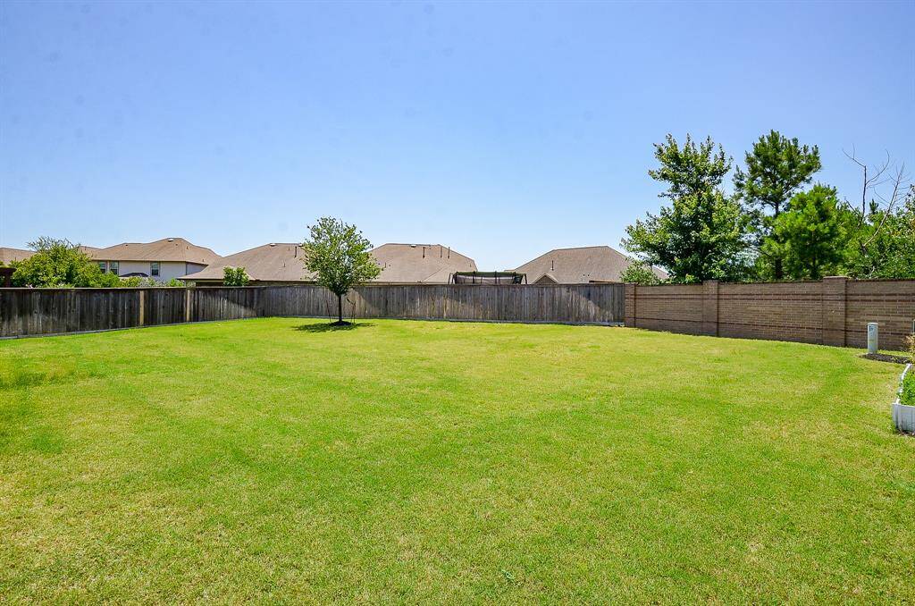 The backyard is an entertainer’s dream with space to spare—imagine a sparkling pool, playset, or backyard garden!