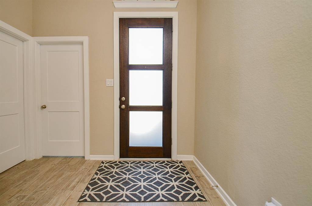 Step into a light-filled foyer that instantly feels like home!