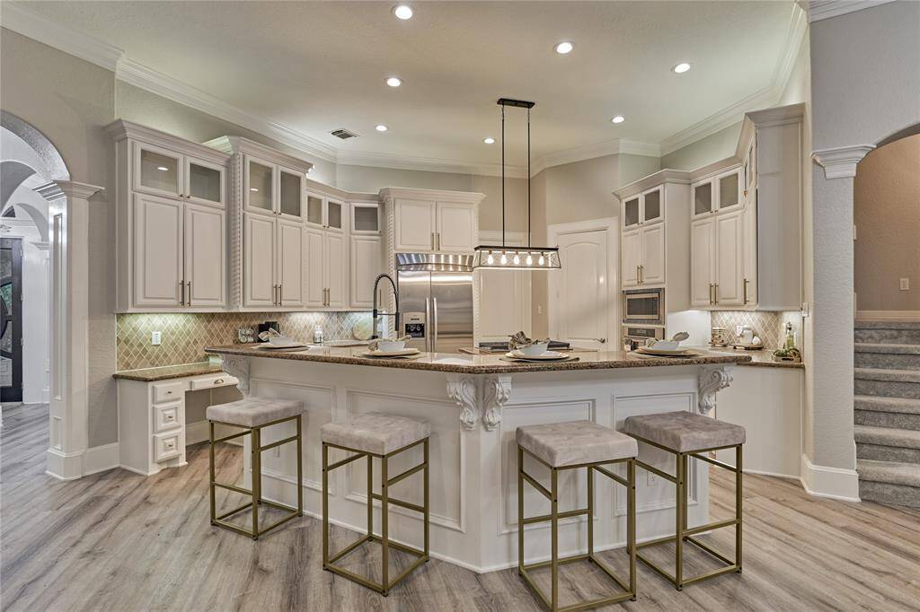Gourmet kitchen with new cooktop, custom cabinetry, and premium stainless steel appliances