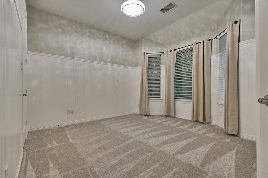 Luxurious primary bedroom with fireplace and backyard views, offering a private hollywood-style suite with separate quarters