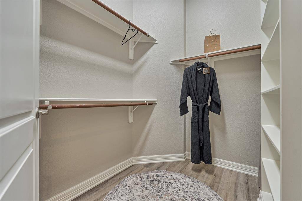 Staircase leading from the kitchen to the half-story, featuring a media room and Texas-style basement.
