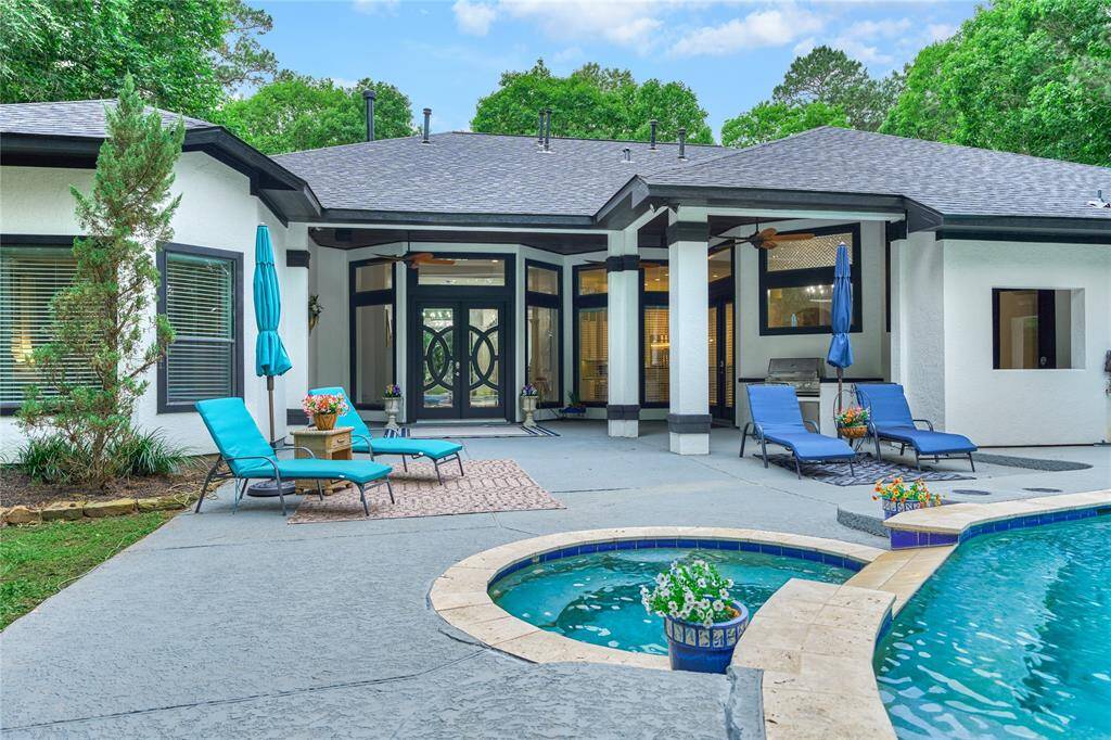 Backyard patio with infinity pool and charming outdoor kitchen, overlooking 1 Acre of HOA land, ensuring privacy with no future development behind-Views of the pond!