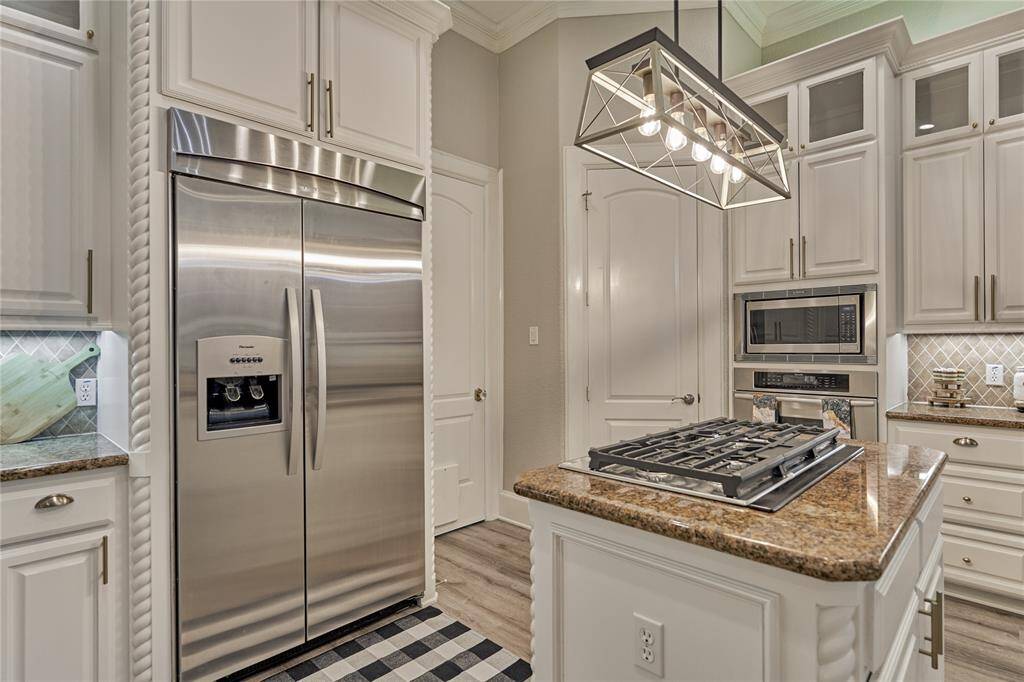 Hollywood inspired primary bath, with a spacious walk-in shower, a standalone soaking tub, and abundant natural light for the perfect blend of elegance and tranquility