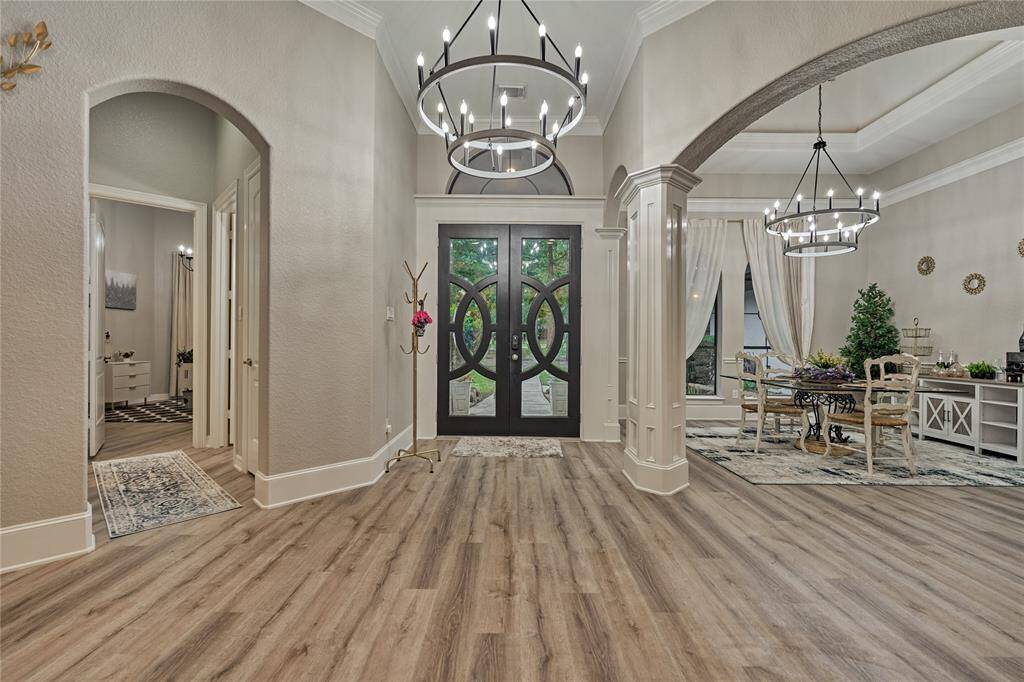 Charming formal sitting area with scenic pool and backyard views.