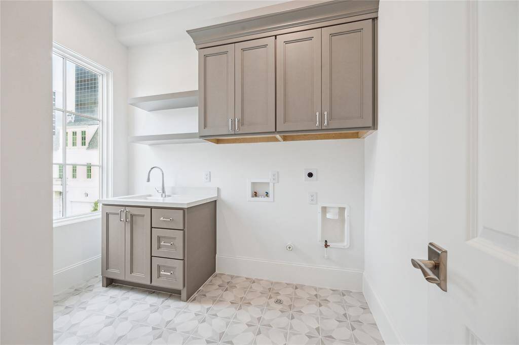 Utility room included on the second floor with plenty of built-in storage, along with Kohler Park Falls enameled cast iron undermount utility sink and Kohler Simplice faucet.
