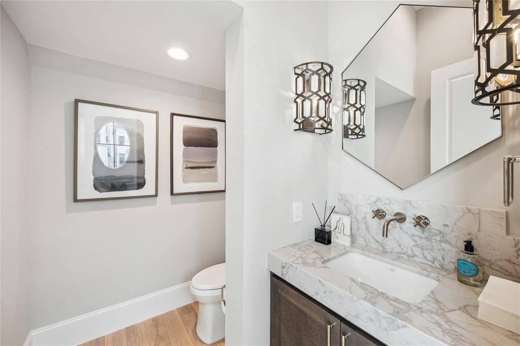 First floor powder features Florence Polished Marble countertop, Kallista luxury fixtures and undermount sink, and additional storage.