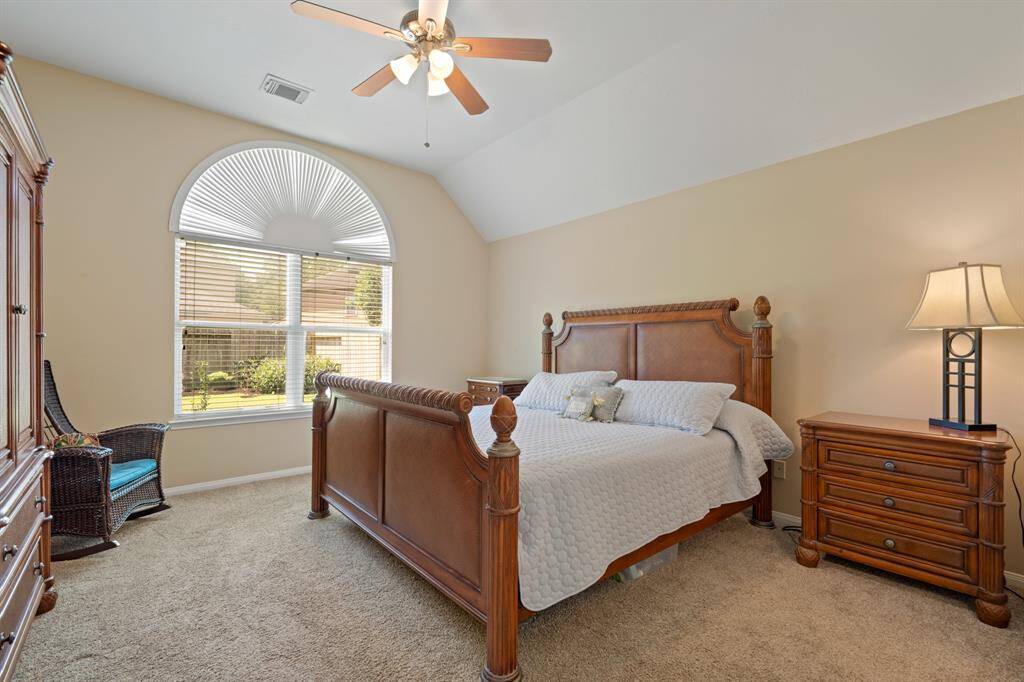 Primary bedroom with ensuite bathroom overlooking the outdoor space.