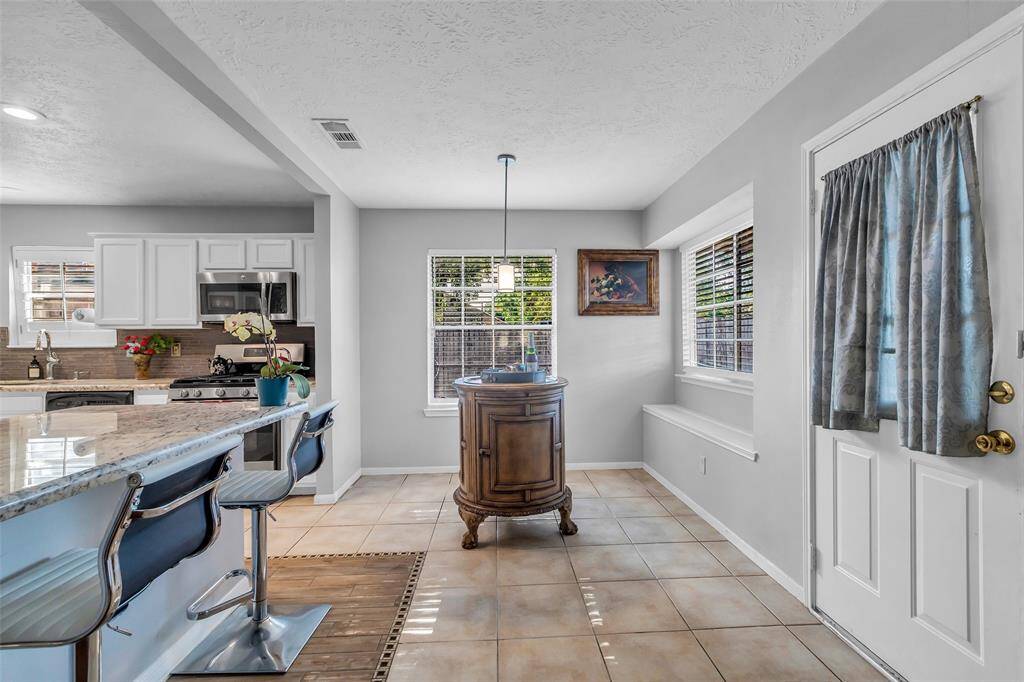 Lovely breakfast area with large windows overlooking the backyard.
