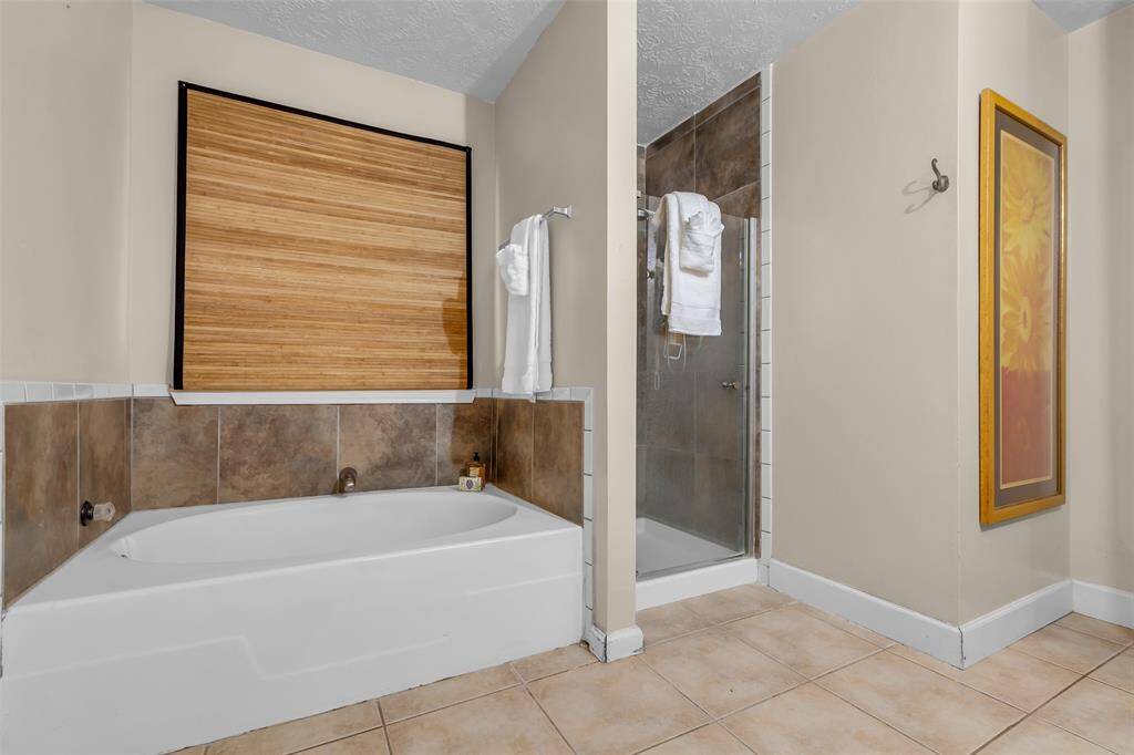 Primary bathroom with a garden tub and separate shower.