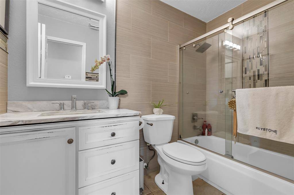 Secondary bathroom with shower and tub.