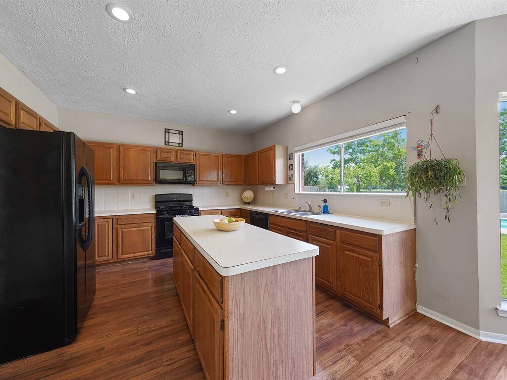 Alternate view of the kitchen. Complemented by a spacious center island that provides additional storage and prep space.