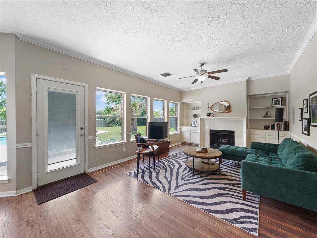 Large windows frame outdoor views and create an airy, open feel in the living room!