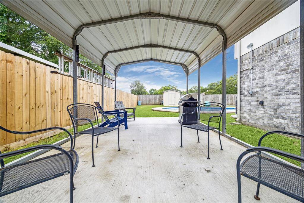 This spacious covered carport with a 6-inch concrete foundation is perfect for boat storage or hosting family gatherings. Enjoy shaded outdoor seating, a BBQ setup, and easy access to the backyard and pool making it an ideal multi-purpose space for relaxing or entertaining.
