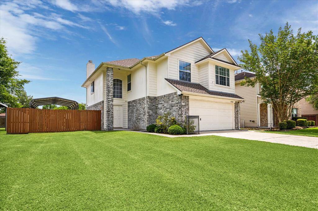 This property features a spacious front lawn and a well-maintained driveway. A wooden fence encloses the side yard, which includes a sturdy 6-inch build carport, perfect for storing a boat. Enjoy both privacy and ample outdoor space.