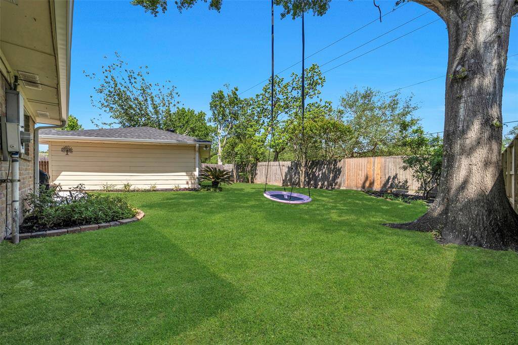 Another look at the backyard. The greenbelt adjacent to the property offers a serene natural backdrop, providing a tranquil escape from the bustling Energy Corridor.