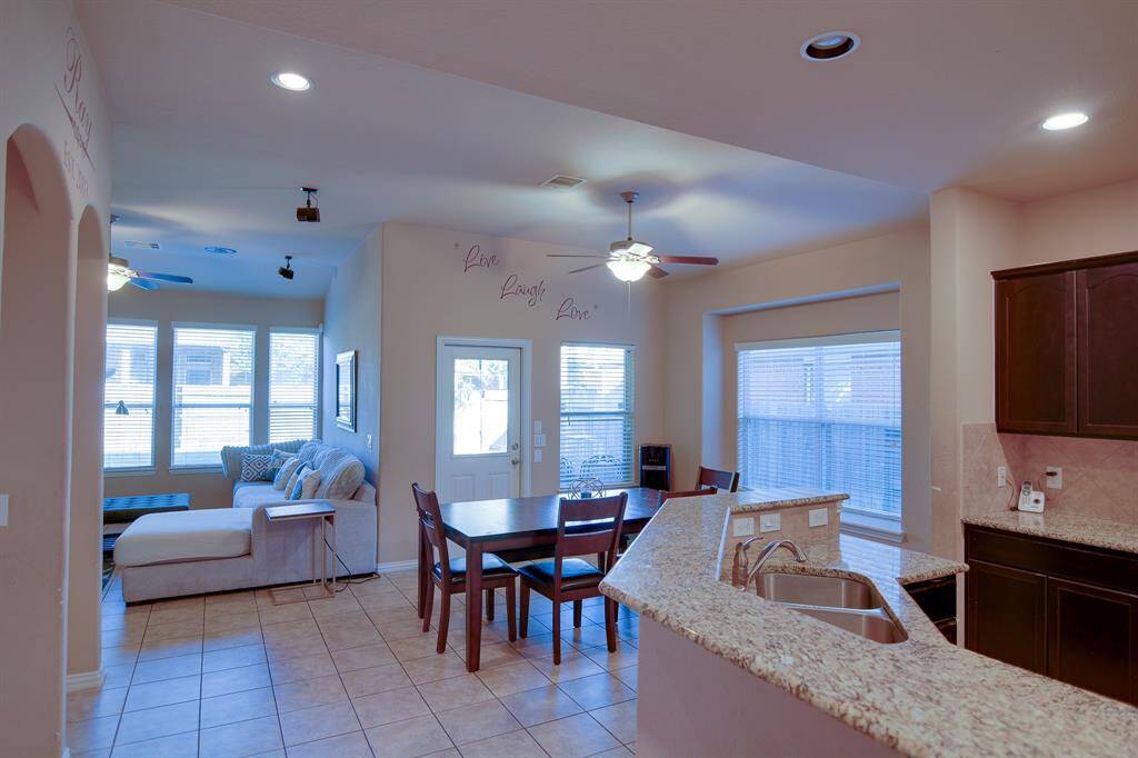 You and your guests will certainly dine in style in this amazing kitchen and dining room! Featuring large windows that open up to your backyard covered patio oasis, neutral paint, high ceilings, and tile flooring. Perfect space to entertain family and friends. Enhancing the flow of indoor-outdoor living.