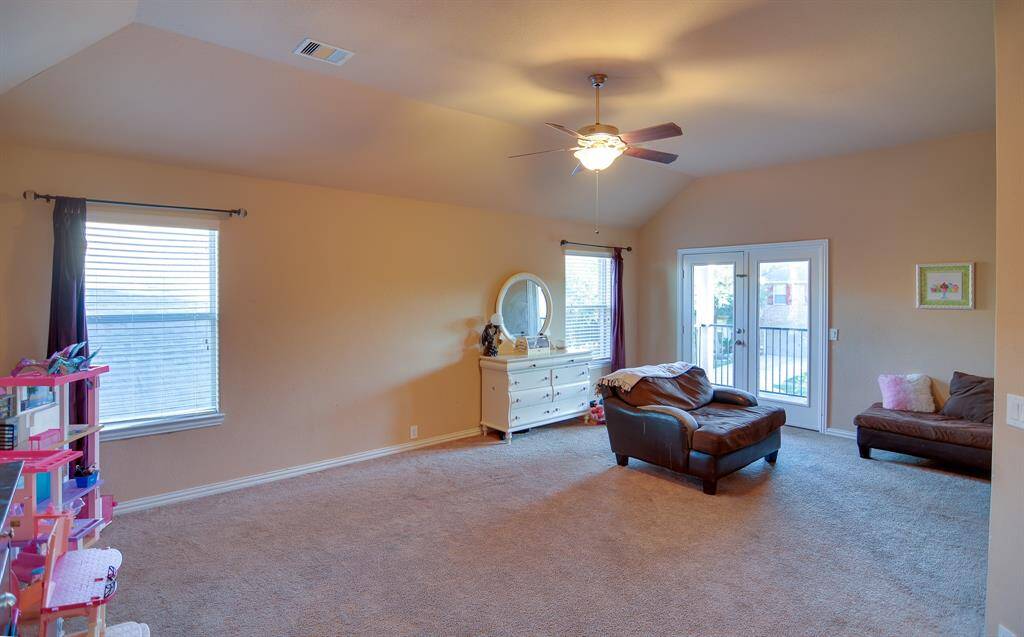 Come and enjoy a day of leisure in this fabulous game room! This is the perfect hangout spot or adult game room, this space features plush carpet flooring, high ceilings, neutral paint, large windows with plenty of natural light and a outdoor balcony.