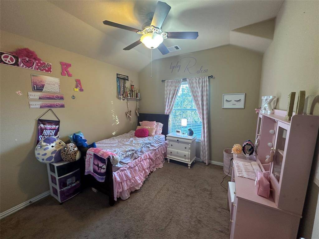 Secondary bedroom features plush carpet flooring, custom paint, and plenty of space to design to your liking.