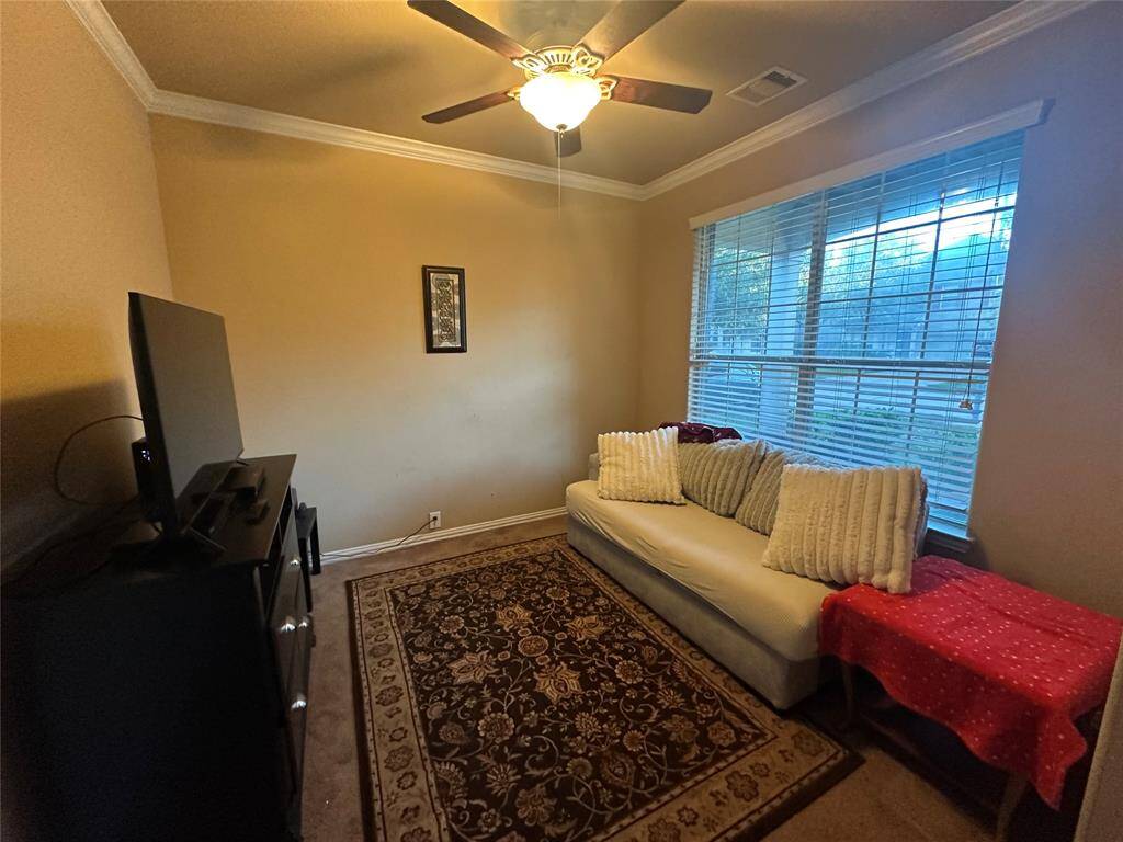 Quietly nestled in the front of the home is the spacious home office. Featuring large windows, high ceilings, neutral paint and crown molding.