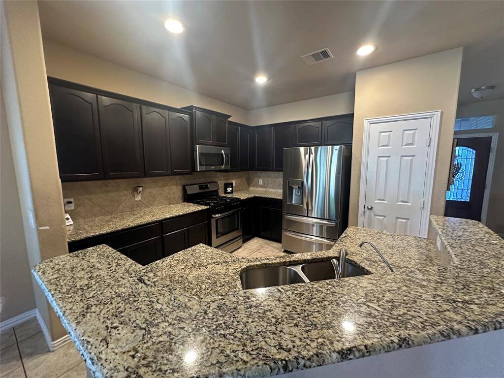 Elegant and modern counters greets you as you enter this beautifully designed kitchen. The stunning granite countertops creates a captivating focal point and illuminating the open kitchen. The sleek granite countertops add a touch of contemporary style, complementing the airy, light-filled space.