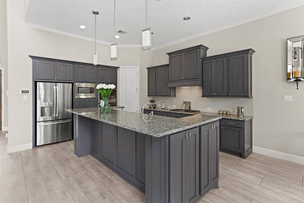 Another view of the kitchen. The kitchen features all stainless steel appliances, double ovens and a 5 burner gas range and refrigerator is included.