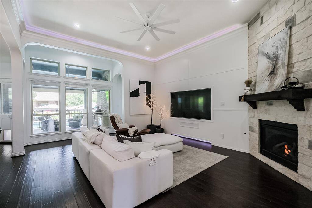 Floor to ceiling stone fireplace with sold wood beam mantel serve as focal point to the Living Room.  Note the wall of windows with views to the lake.