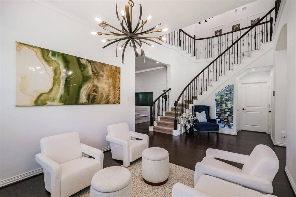 View of Formal Dining Room with view to winding staircase up to Secondary bedrooms, Media Room, Game Room and Office.