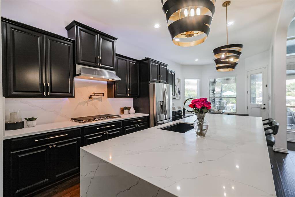 Look at this beautiful waterfall Quartz island with sink and semi-pro faucet.