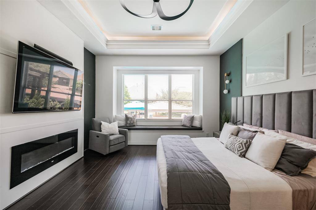 Primary Suite with built in window bench overlooking the lake and electric fireplace.