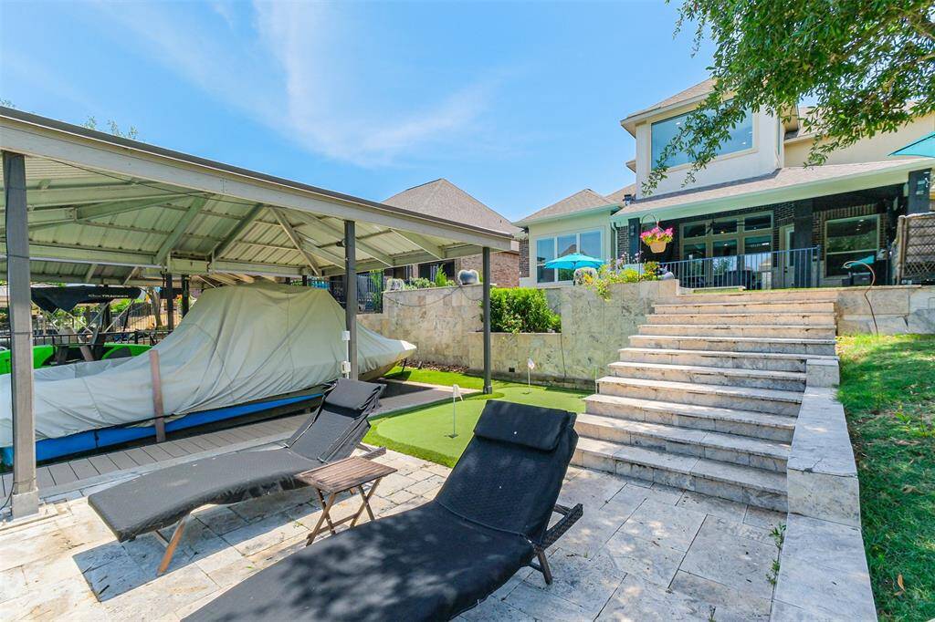 Travertine decking and steps lead to your own private boat slip with hydraulic lift.
