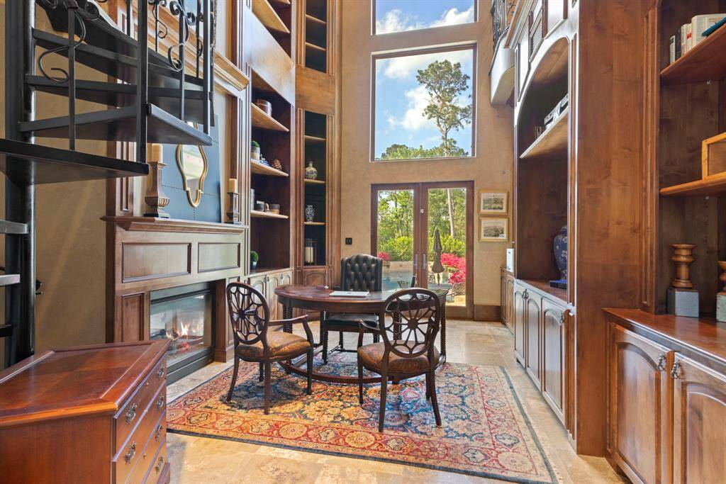 Handsome two-story study enjoys access to the patio and plenty of natural light.