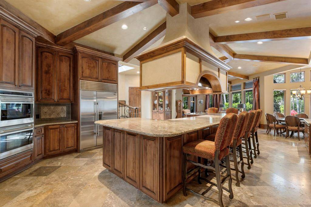 Knotty Alder cabinets are plentiful and an oversized island features plenty of wrap around seating.