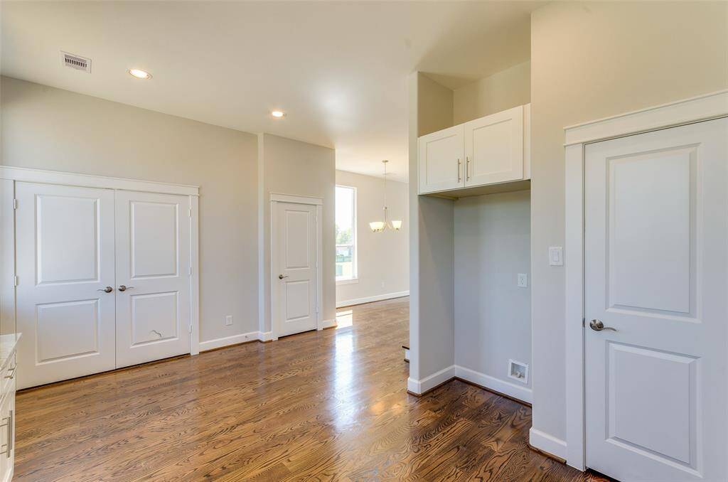 LOOKING AT BREAKFAST ROOM WITH FULL LAUNDRY BEHIND DOUBLE DOORS, TO THE RIGHT IS POWDER ROOM