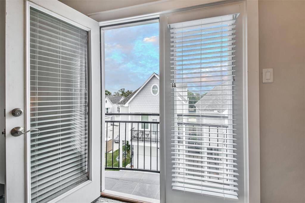 PRIMARY BEDROOM FEATURES TRAY CEILING, DOUBLE FRENCH DOORS WITH A JULIET STYLE BALCONY