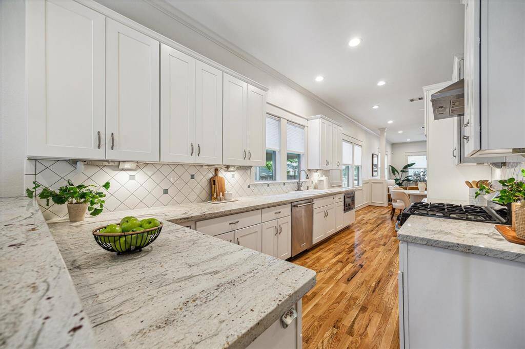 Bright and spacious kitchen with quartz countertops, ample cabinetry and a generous workspace for all your culinary adventures.
